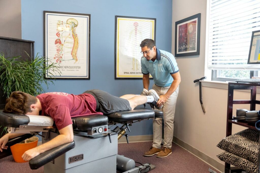 Goshen Family Chiropractic's Dr. Raj performing chiropractic adjustments to improve holistic wellness for a West Chester patient