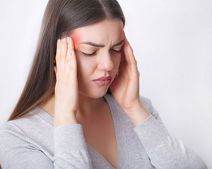 Woman experiencing a stress induced headache 