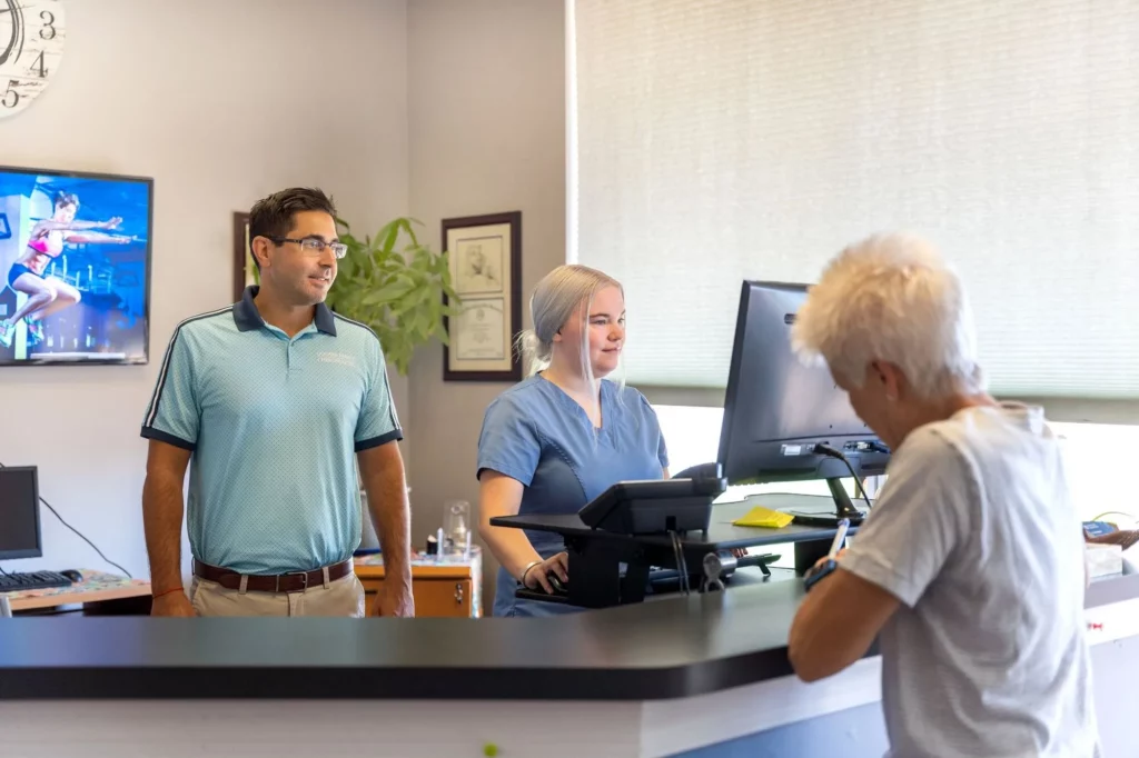 The friendly team at Goshen Family Chiropractic helping a patient at their office