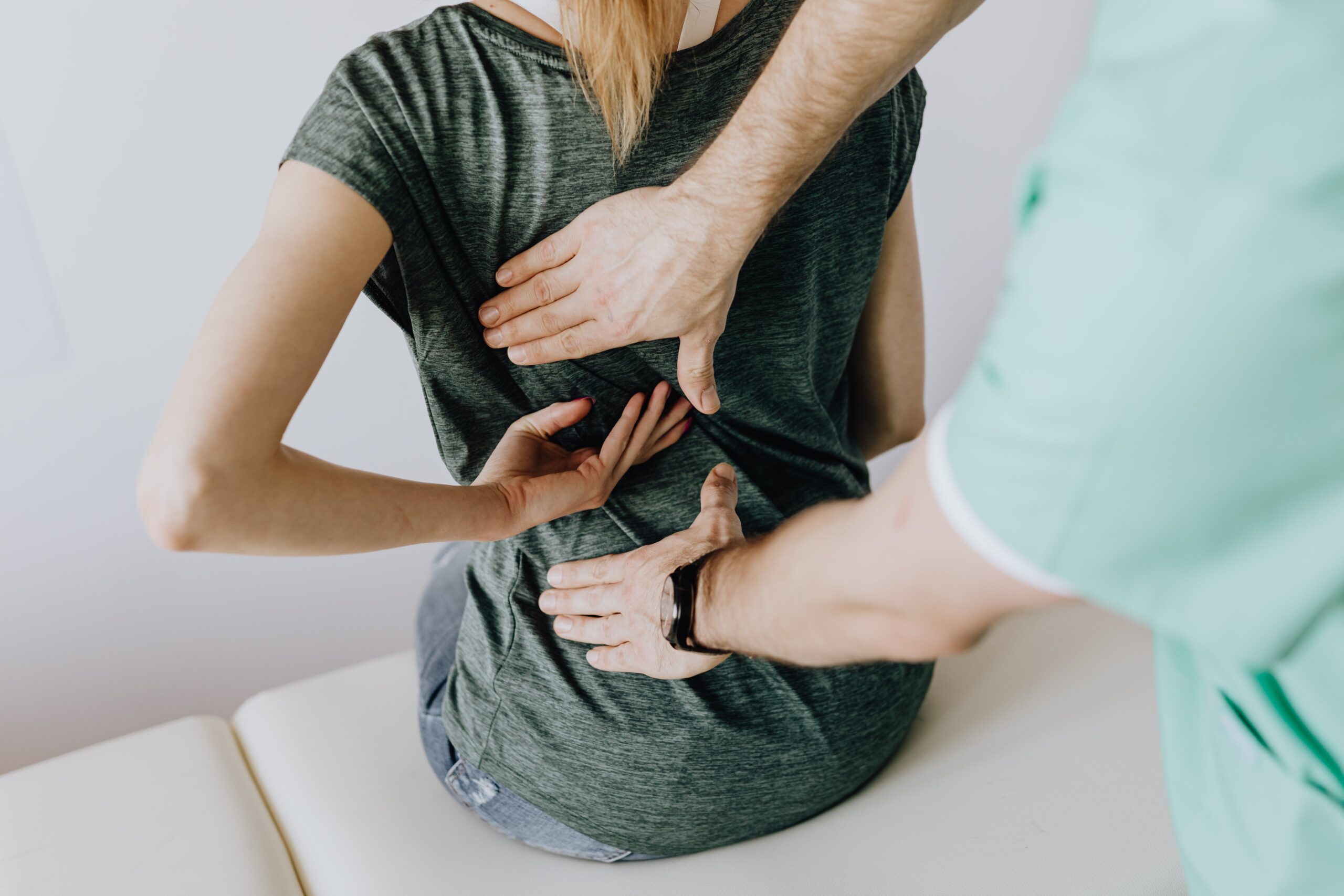 A woman receiving chiropractic care to treat her hip pain