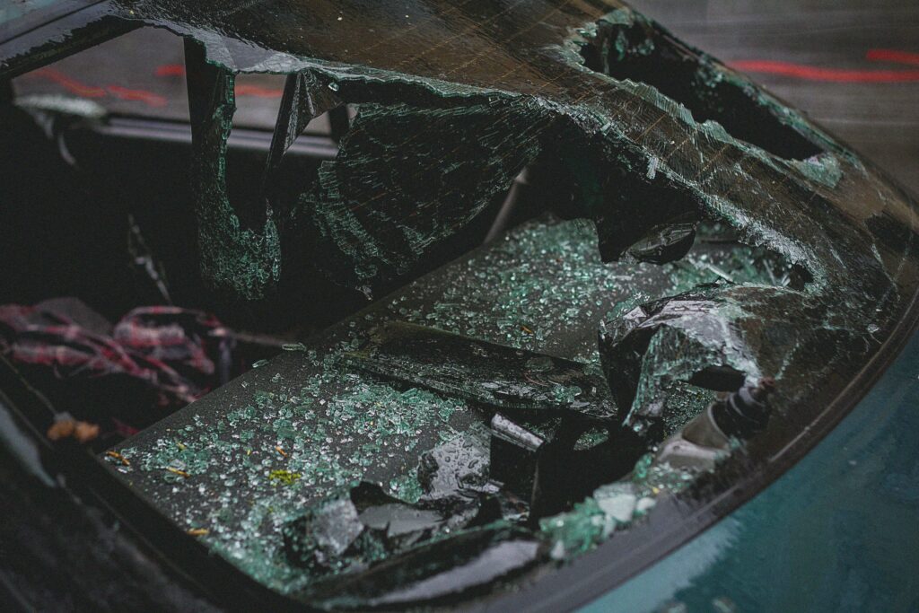 a closeup of a broken car windshield after an accident