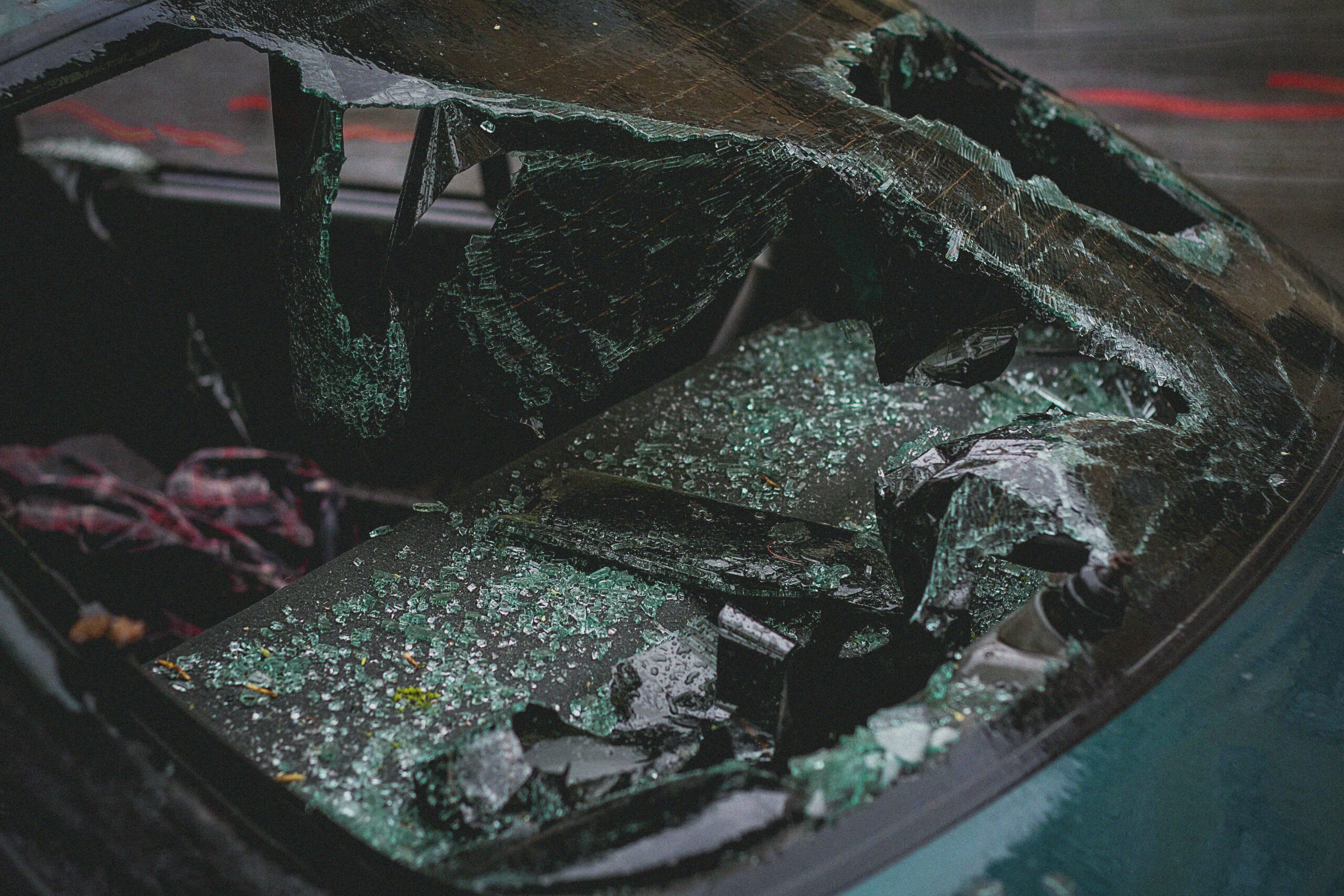 a closeup of a broken car windshield after an accident