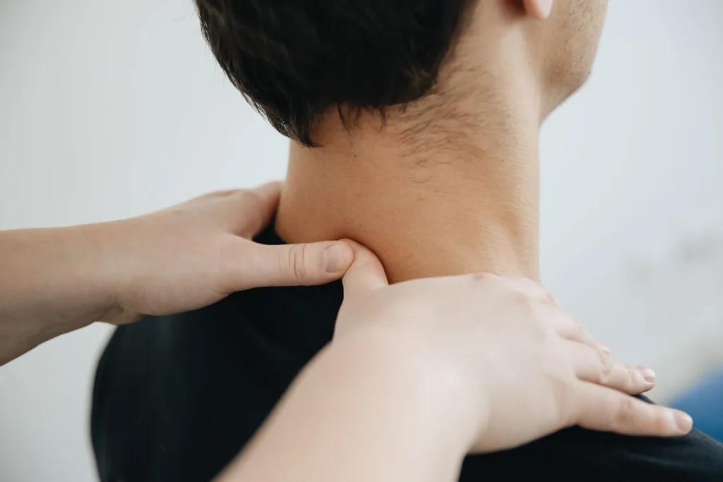 a chiropractor performing chiropractic adjustments on a pinched nerve patient's neck.
